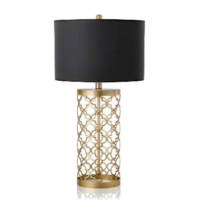 golden hollowed out base table lamp with dark shade