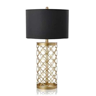 golden hollowed out base table lamp with dark shade