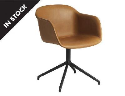 fiber armchair upholstered in cognac leather black swivel base with return by iskos berlin muuto